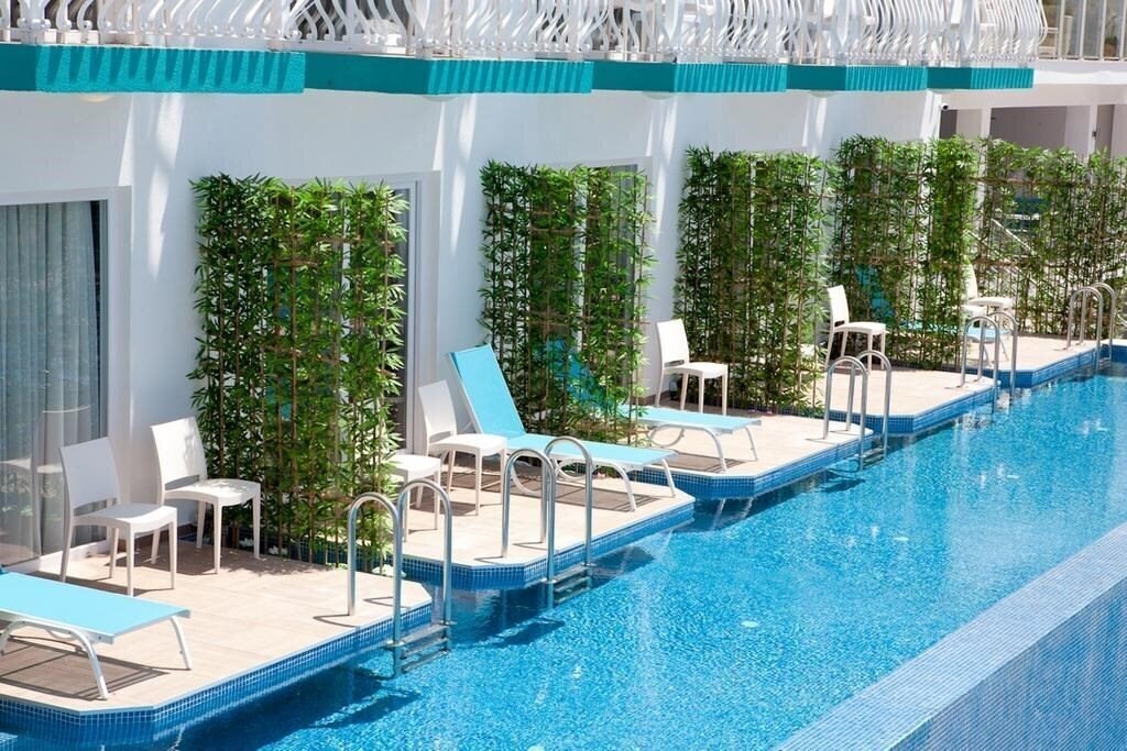 Фото Sertil Deluxe Hotel & SPA (ex. Tropical Suites by Sertil, Ramada by Wyndham Fethiye Oludeniz) 4*